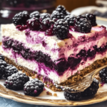 A slice of blackberry icebox cake, featuring layers of creamy filling, fresh blackberries, and graham crackers, topped with more berries and a drizzle of sauce.