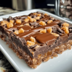 Caramel Chocolate Crunch Bars with a crispy base, gooey caramel layer, and smooth chocolate topping, cut into squares and displayed on a rustic tray.