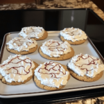 Cool Whip Cookies dusted with powdered sugar, showcasing their light and fluffy texture, arranged on a rustic wooden tray for a cozy presentation.