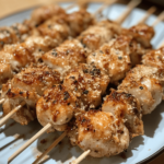 Air Fryer Garlic Parmesan Chicken Skewers with golden, crispy edges and tender chicken pieces, garnished with fresh parsley and served on a platter.