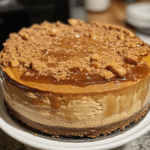 Salted Caramel Biscoff Cheesecake with a Biscoff cookie crust, smooth cheesecake filling, and a drizzle of salted caramel, garnished with a Biscoff cookie on top.