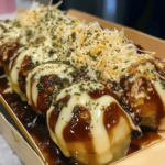 Takoyaki with Cheese Supremacy, golden and crispy on the outside, filled with gooey cheese and octopus, topped with sauce, mayo, and bonito flakes, served on a traditional takoyaki plate.