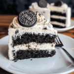 Decadent Oreo Cake with layers of chocolate cake and Oreo buttercream, topped with crushed Oreo cookies and a drizzle of chocolate sauce.